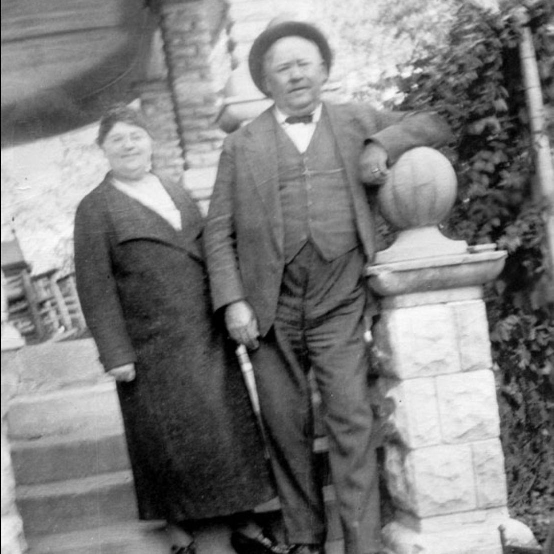 Two people standing on porch stairs