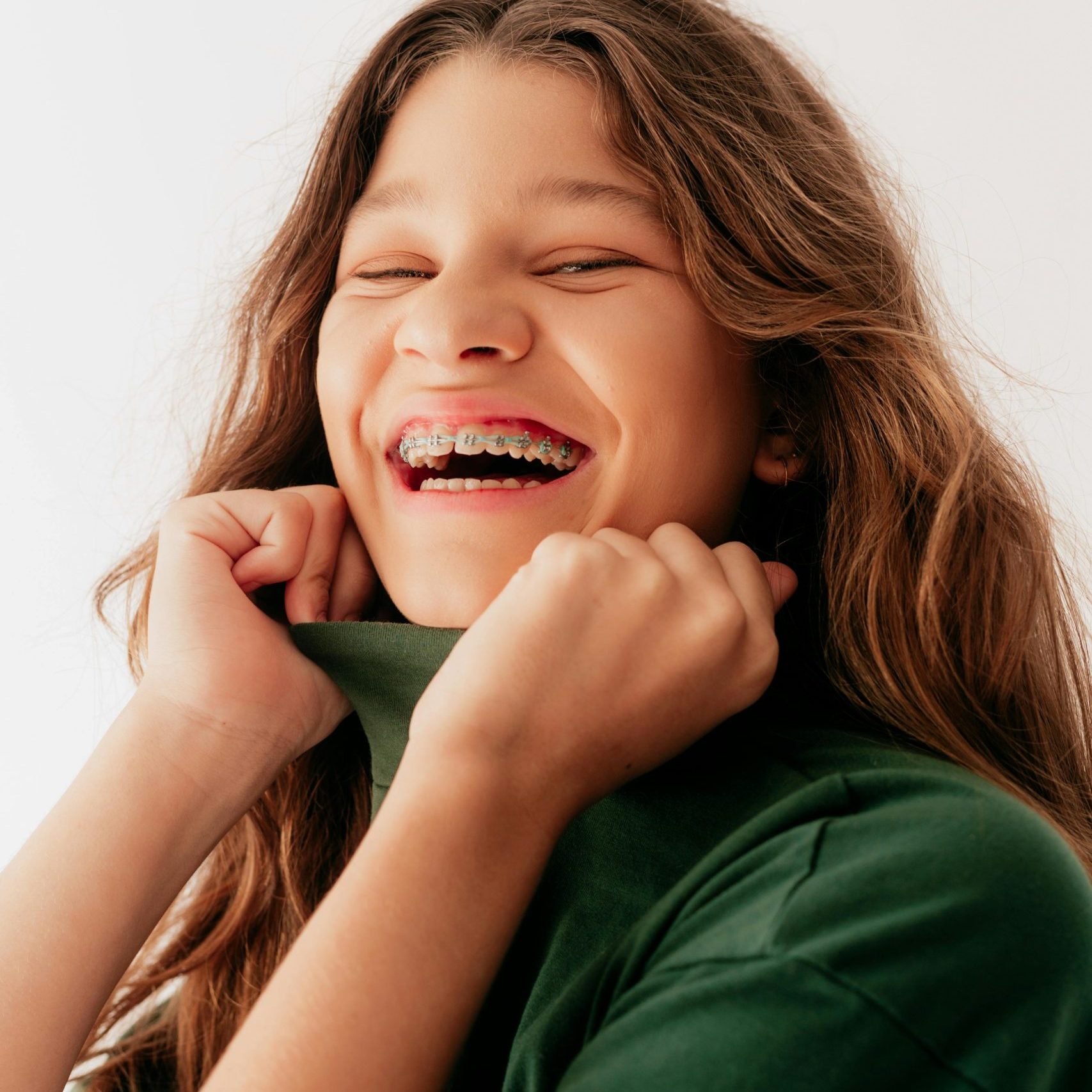 Girl with braces laughing.