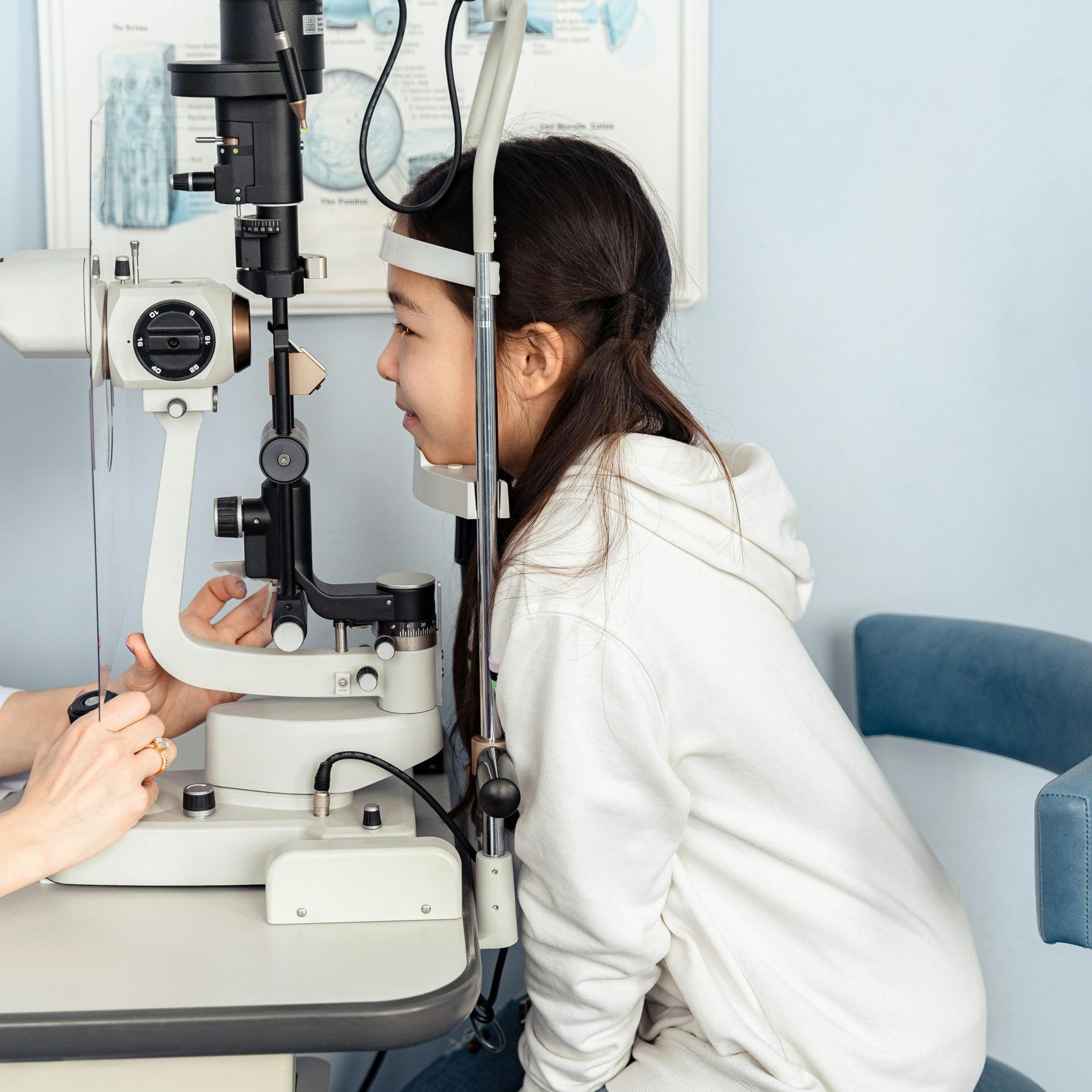Girl leaning into an optometry tool.